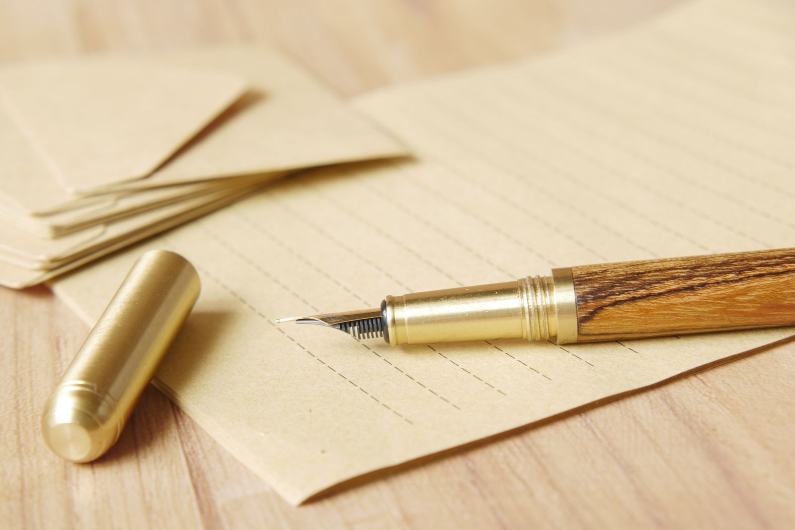 A fountain pen resting on lined paper, evoking a handwritten will